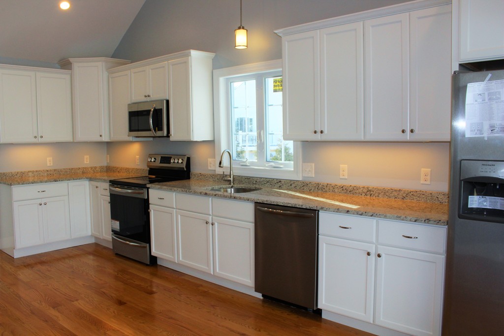 396 Reed Road Dartmouth, MA 02747 - Photo 13 of 13 a kitchen with granite countertop white cabinets and white appliances