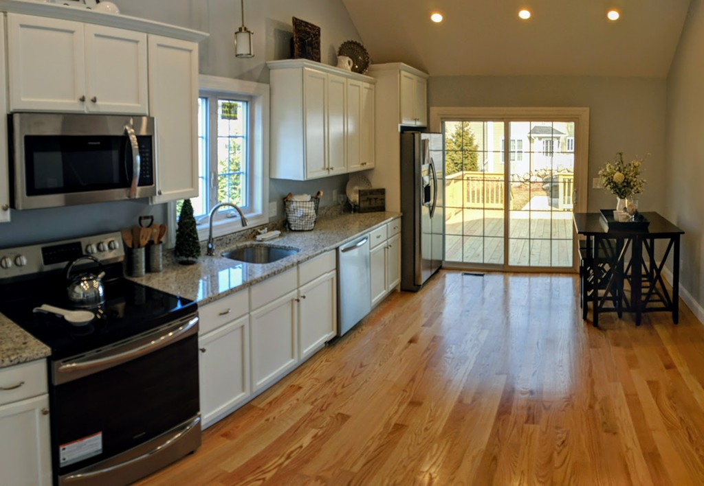 396 Reed Road Dartmouth, MA 02747 - Photo 2 of 13 a kitchen with counter top space a sink wooden floor and stainless steel appliances