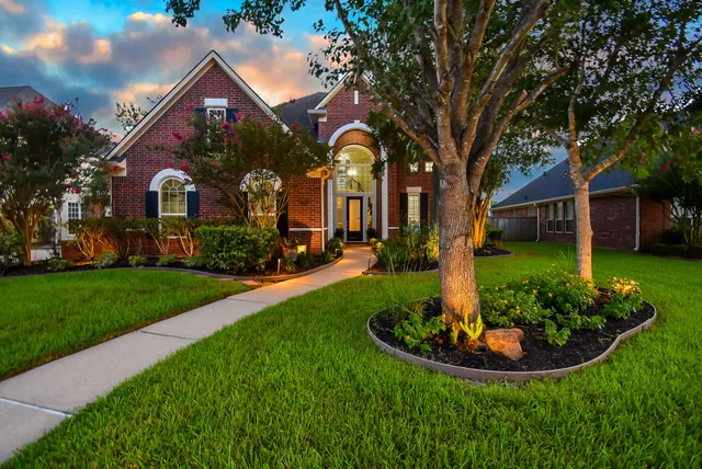 a front view of house with yard and green space