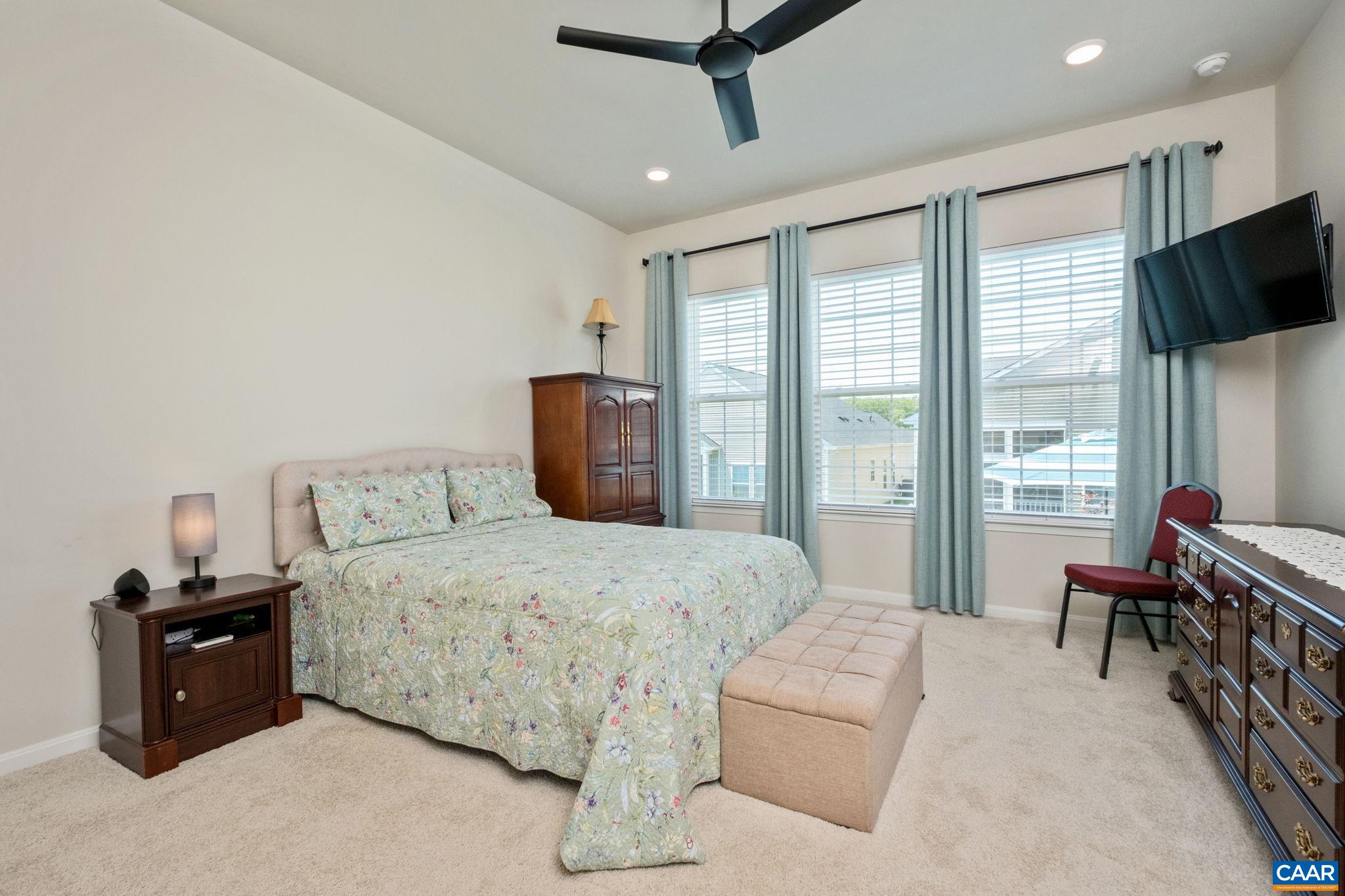 124 Stodghill Drive Ruckersville, VA 22968 - Photo 30 of 58 a bedroom with a bed flat screen tv and a large window