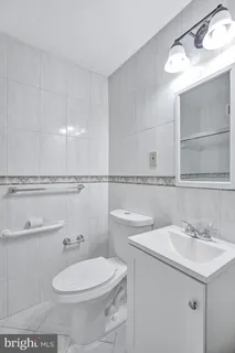 a bathroom with a toilet a sink and mirror