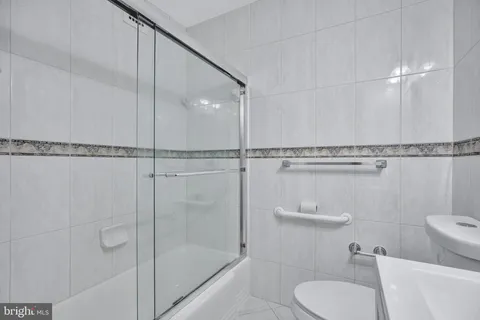 a bathroom with a shower a toilet and sink