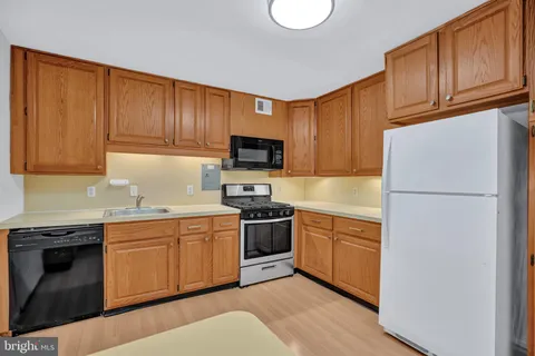 a kitchen with a sink stove and refrigerator