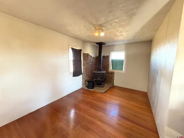 a view of a livingroom with furniture and a window