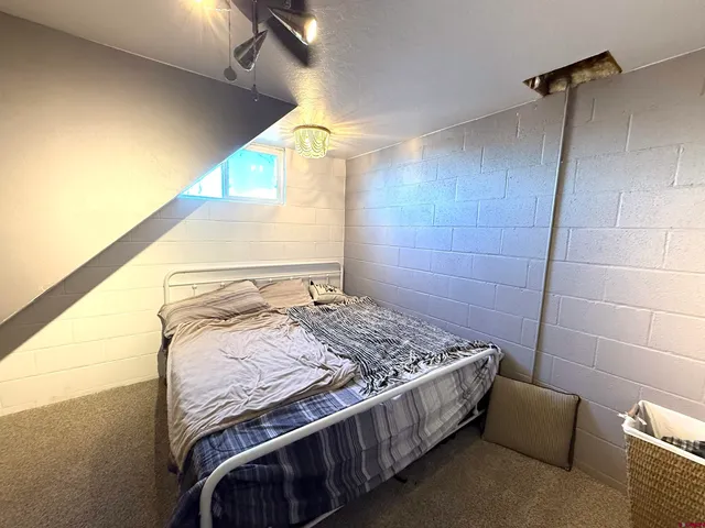 a bedroom with a bed and a mirror