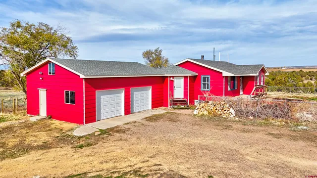 a view of a house with a yard and garage