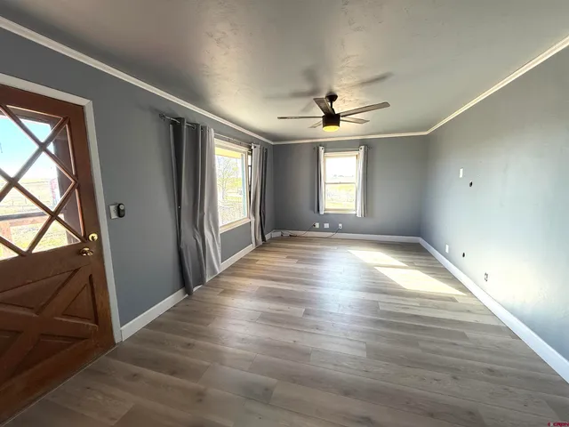 wooden floor in an empty room with a window