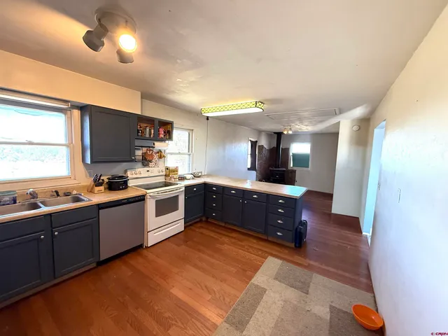 a large kitchen with stainless steel appliances and a large counter top