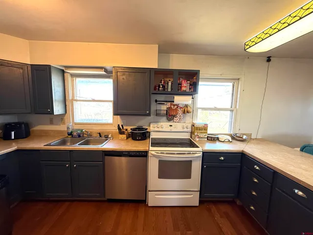 a kitchen with a sink and a stove