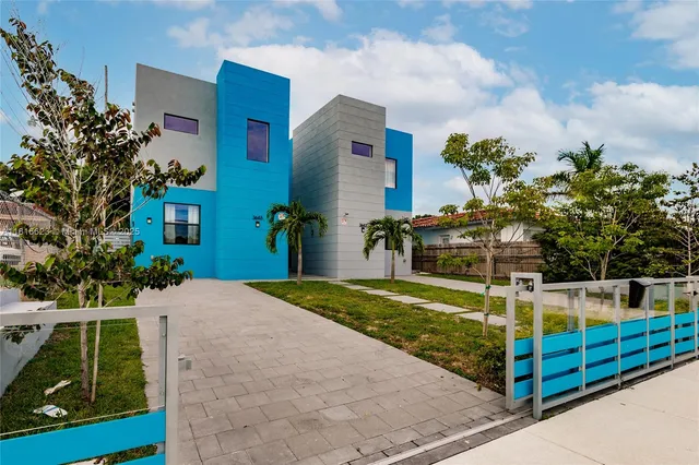 a front view of a house with a garden