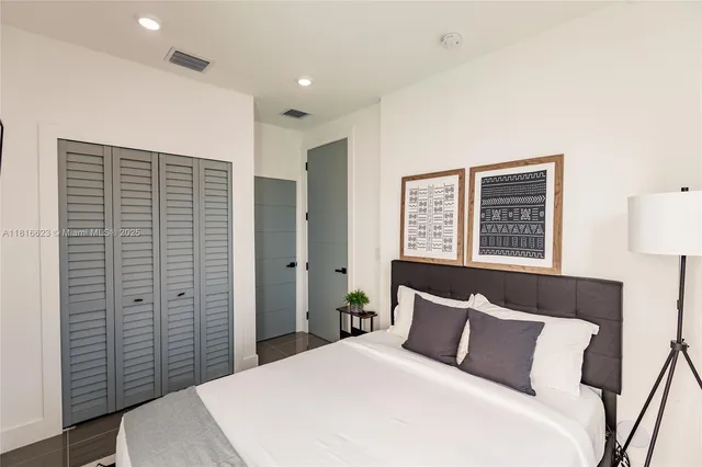 a bedroom with a large bed and a closet