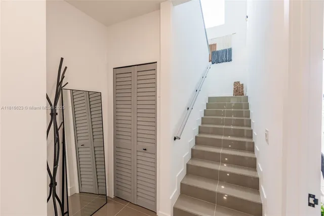 a view of staircase with white walls and windows