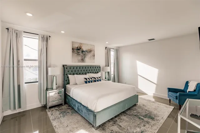 a bedroom with a large bed and a window