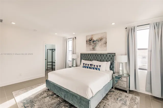 a bedroom with a large bed and a window