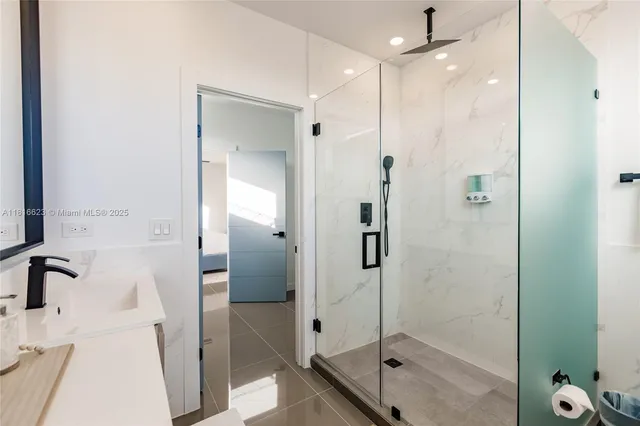 a bathroom with a shower and a glass door