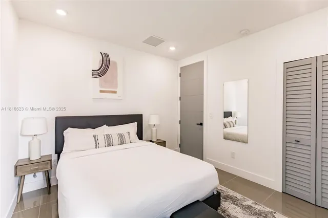 a bedroom with a bed and painting on the wall