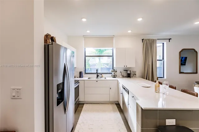 a kitchen with a sink stove and refrigerator