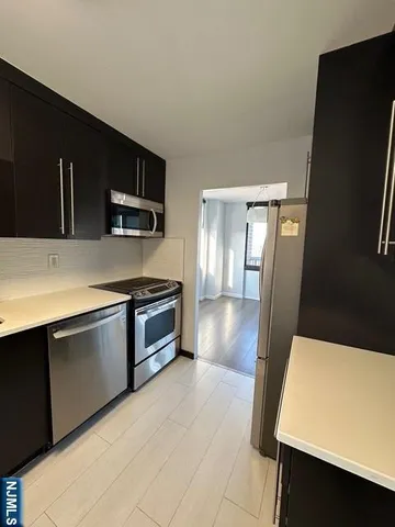 a stove top oven sitting inside of a kitchen