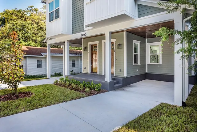 front view of a brick house with a yard