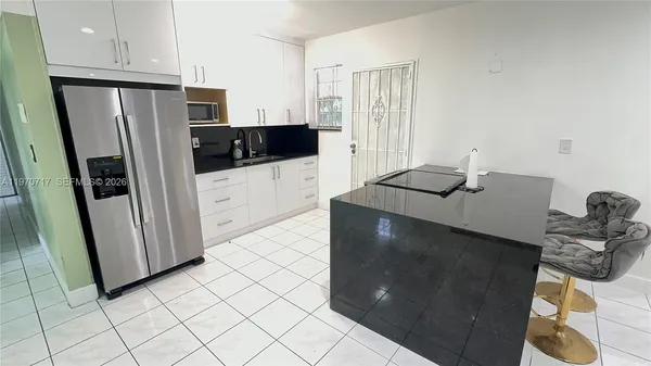 a kitchen with stainless steel appliances a refrigerator and a stove