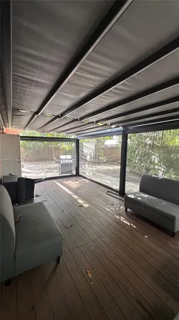 a view of livingroom with furniture and large windows