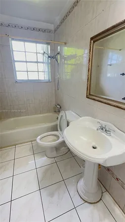a bathroom with a sink a toilet and mirror