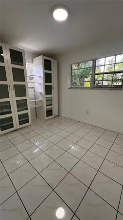 a view of an empty room with a window