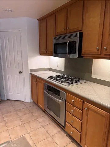 a kitchen with granite countertop a stove and a microwave
