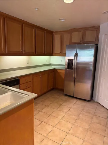 a kitchen with stainless steel appliances a sink and a refrigerator