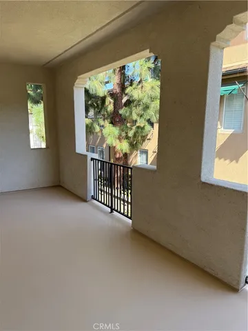 a view of a porch with wooden floor and windows