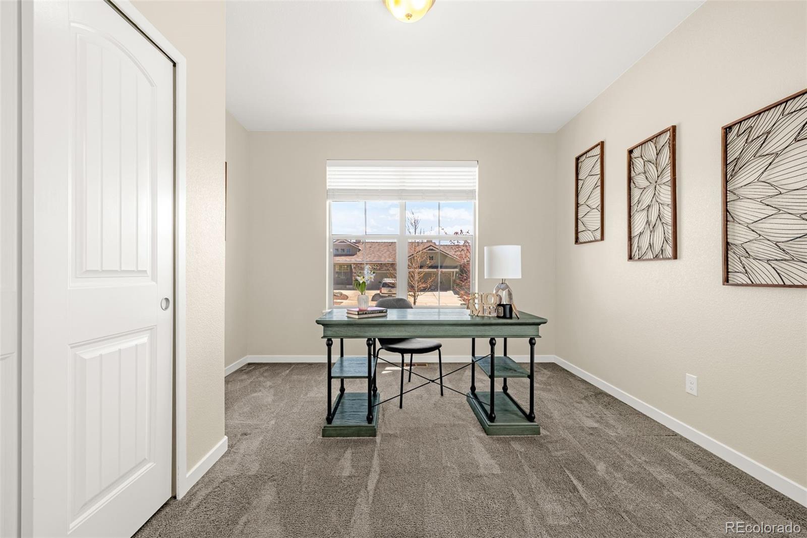 2052 Ruffino Drive Colorado Springs, CO 80921 - Photo 18 of 36 a view of a workspace with furniture and a window