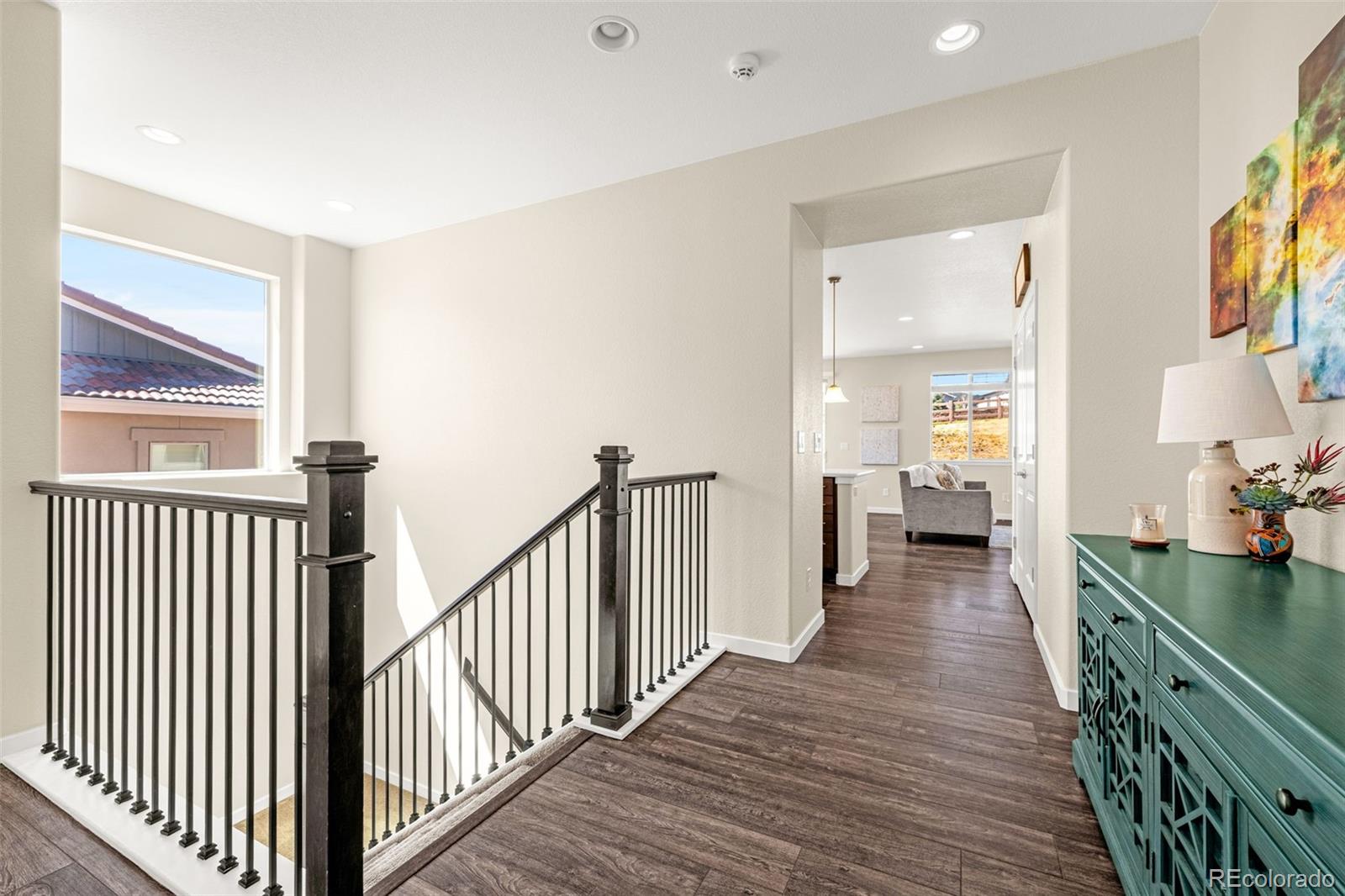 2052 Ruffino Drive Colorado Springs, CO 80921 - Photo 2 of 36 a view of a hallway with wooden floor and a living room