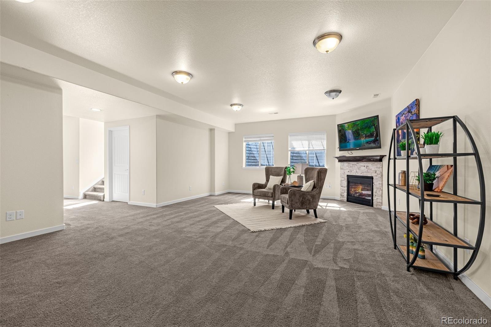 2052 Ruffino Drive Colorado Springs, CO 80921 - Photo 22 of 36 a view of a livingroom with furniture and a flat screen tv