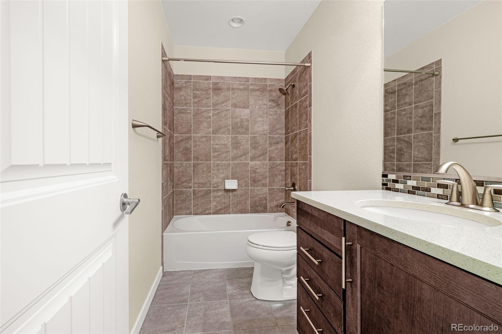 2052 Ruffino Drive Colorado Springs, CO 80921 - Photo 26 of 36 a bathroom with a sink a toilet and shower