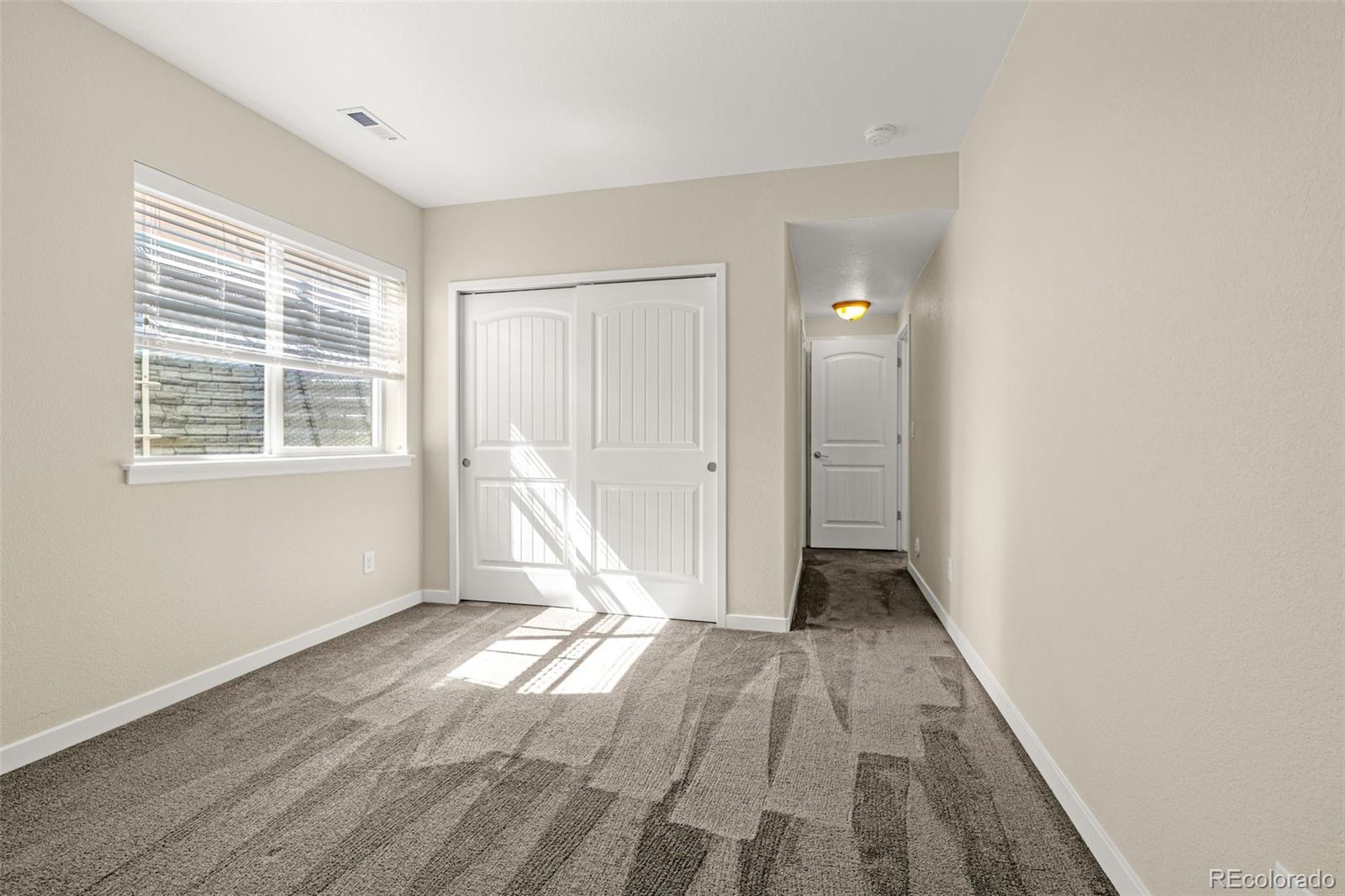 2052 Ruffino Drive Colorado Springs, CO 80921 - Photo 28 of 36 a view of an empty room with wooden floor and a window