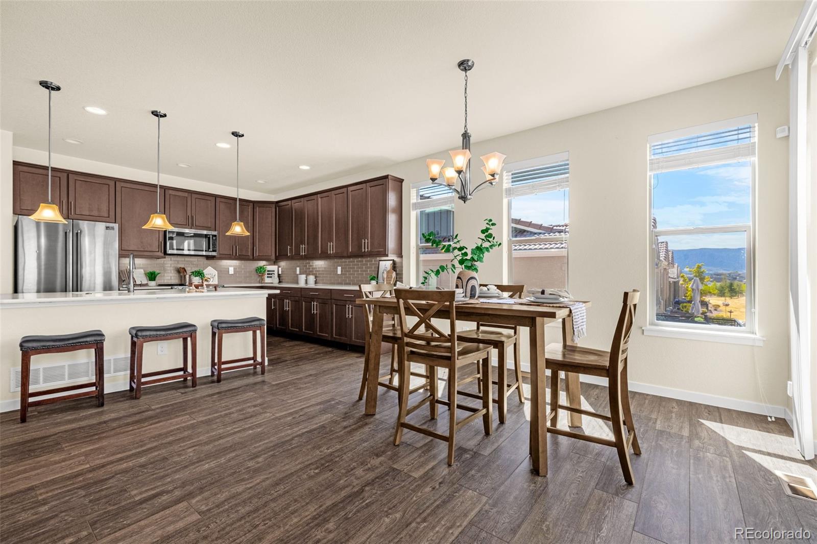 2052 Ruffino Drive Colorado Springs, CO 80921 - Photo 7 of 36 a view of a dining room with furniture and wooden floor