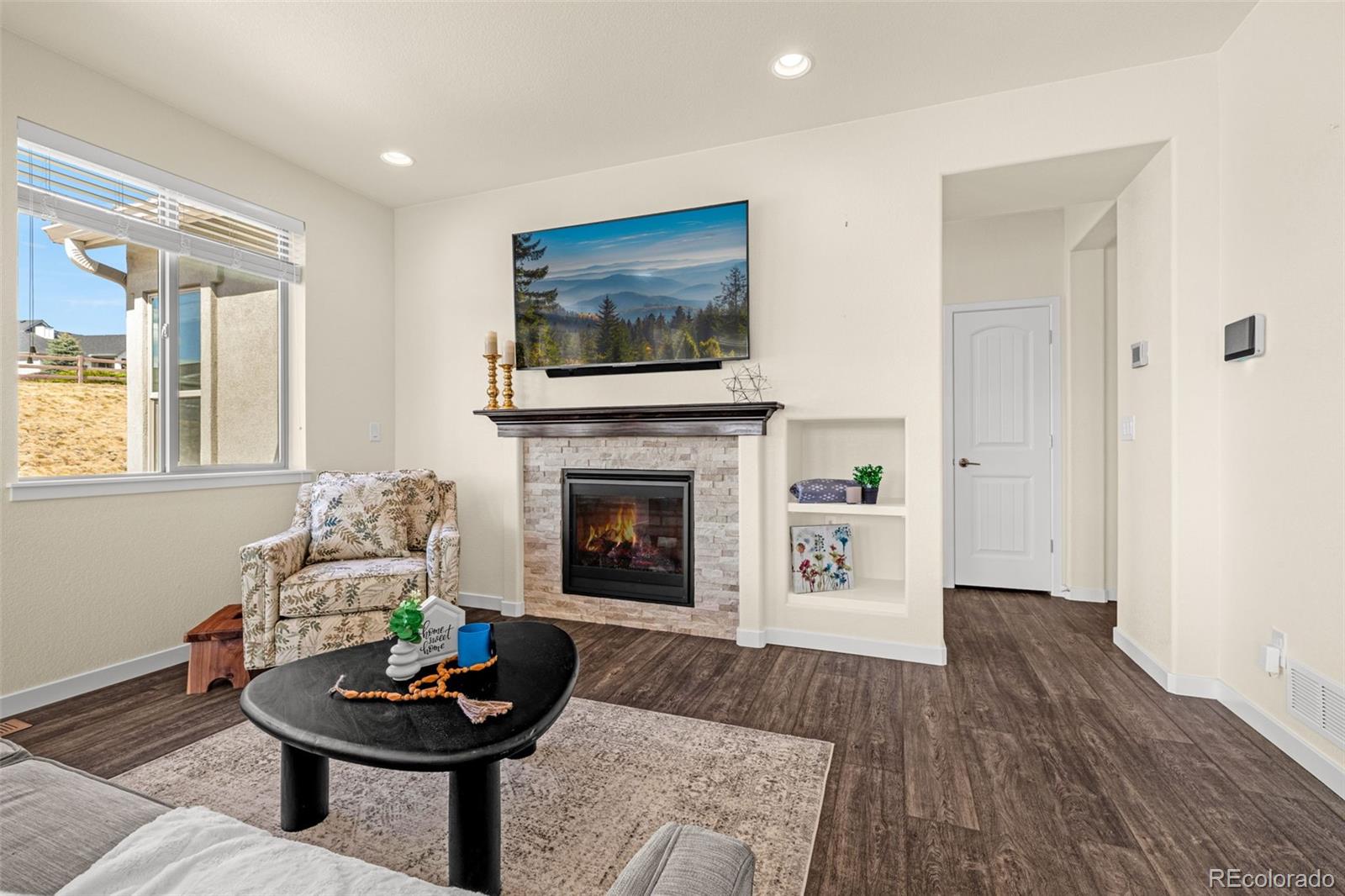 2052 Ruffino Drive Colorado Springs, CO 80921 - Photo 10 of 36 a living room with furniture and a fireplace