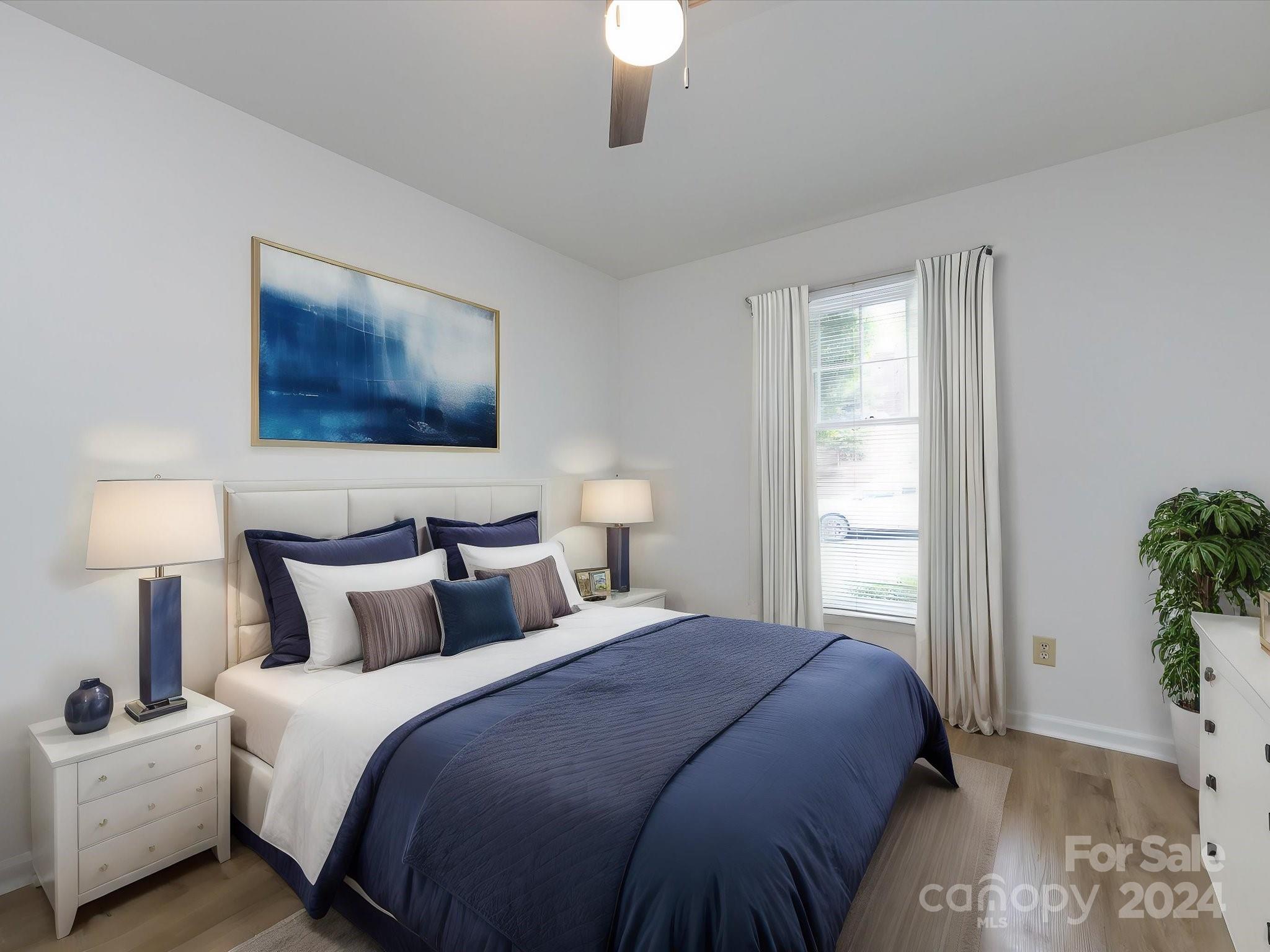 430 Queens Road, Unit 112 Charlotte, NC 28207 - Photo 14 of 19 a bedroom with a bed and a lamp