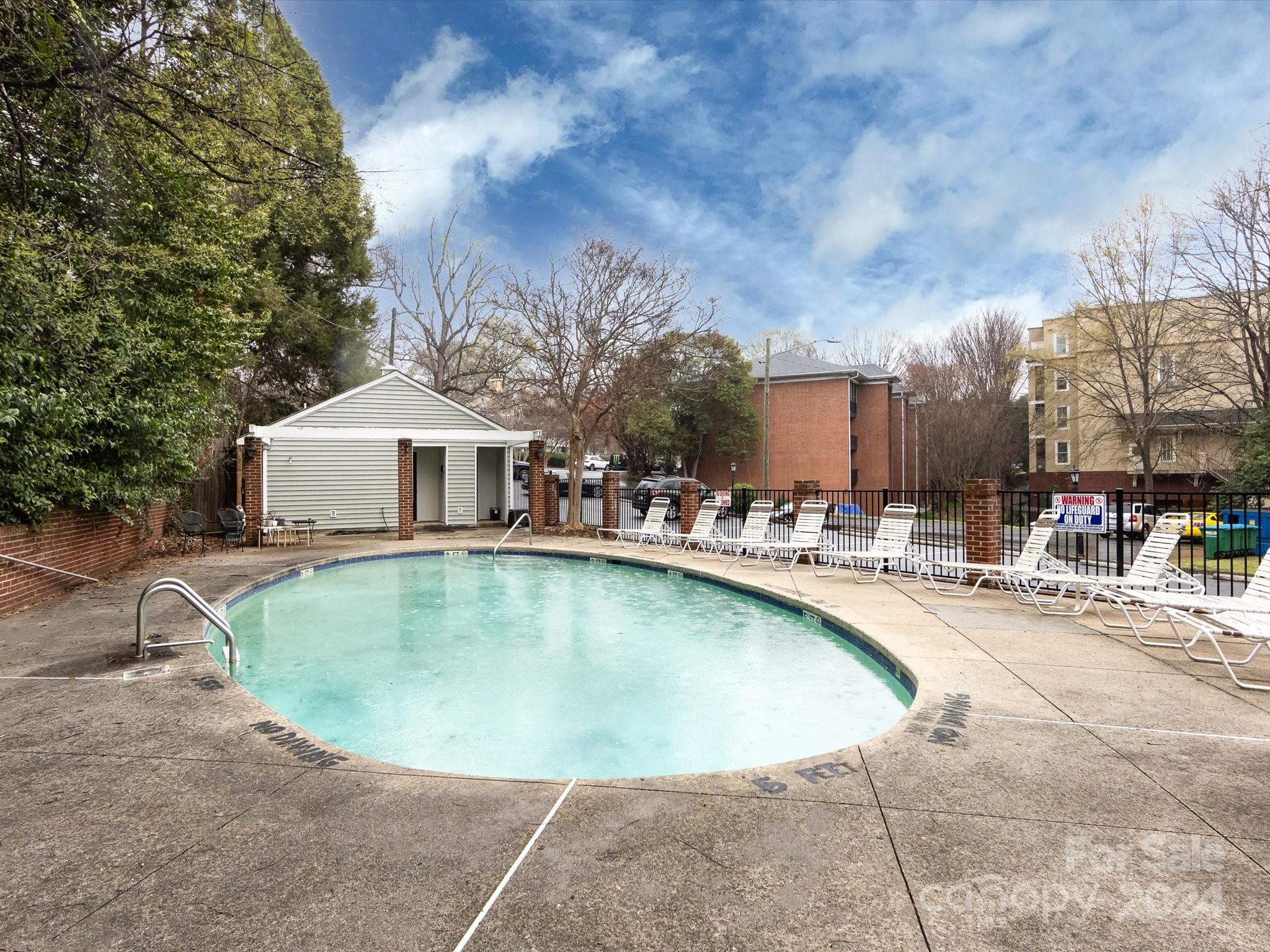 430 Queens Road, Unit 112 Charlotte, NC 28207 - Photo 19 of 19 a view of a house with swimming pool and sitting area