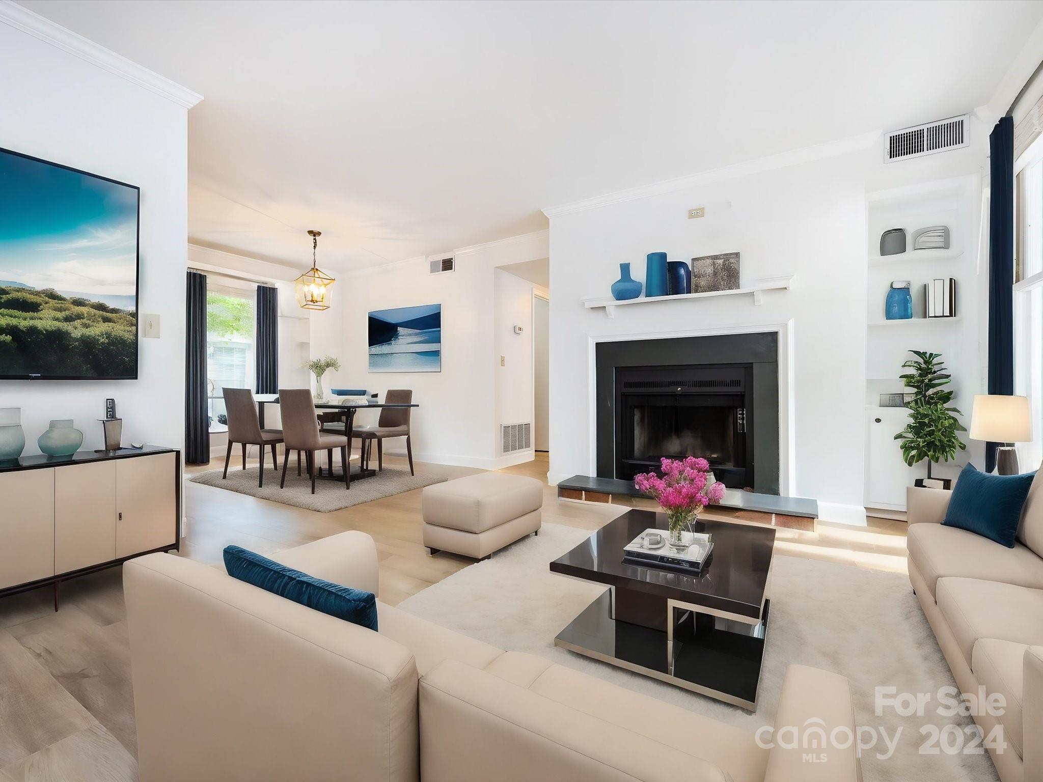 430 Queens Road, Unit 112 Charlotte, NC 28207 - Photo 3 of 19 a living room with furniture and a fireplace