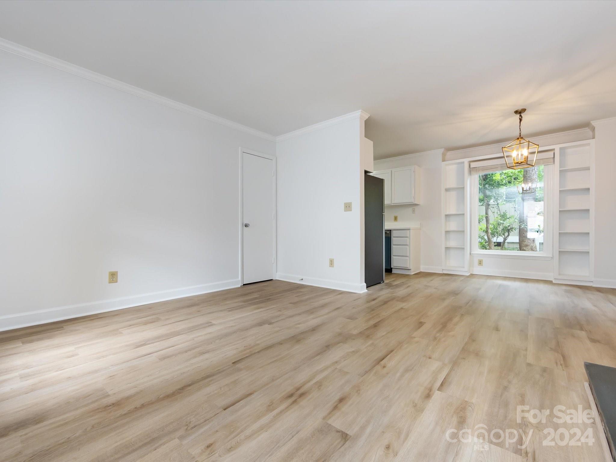 430 Queens Road, Unit 112 Charlotte, NC 28207 - Photo 6 of 19 a view of an empty room with a window
