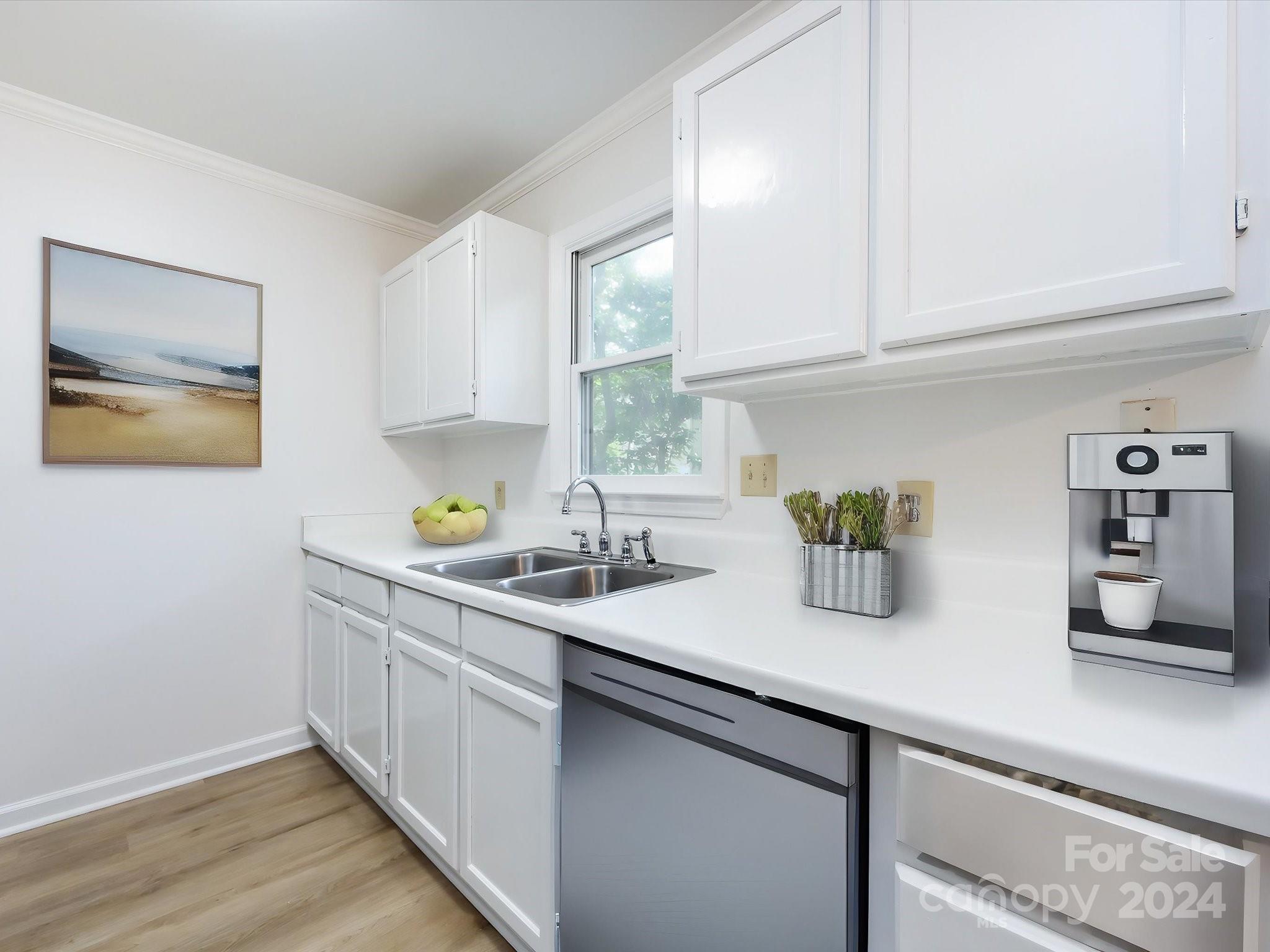 430 Queens Road, Unit 112 Charlotte, NC 28207 - Photo 9 of 19 a kitchen with a sink and cabinets