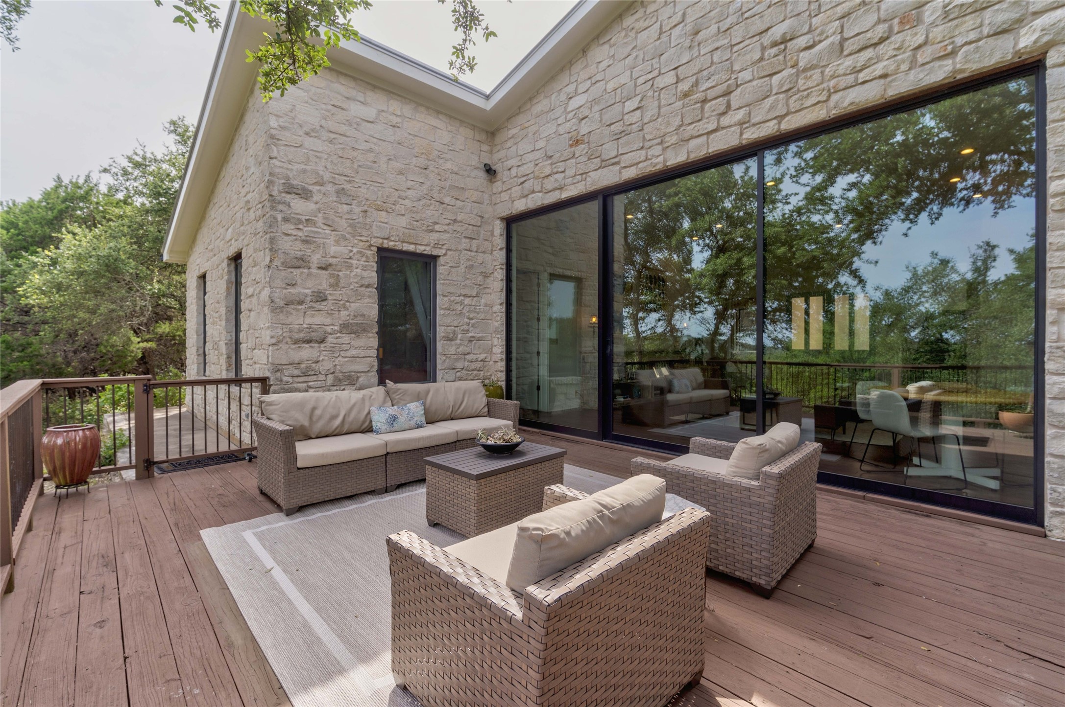 2102 Paisano Road Austin, TX 78746 - Photo 2 of 26 Wooden terrace with an outdoor hangout area