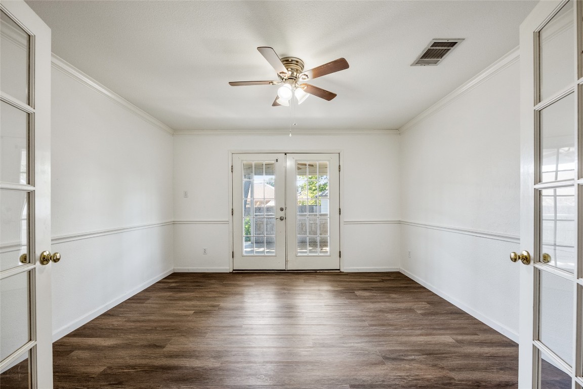 1564 Lorson Loop Round Rock, TX 78665 - Photo 11 of 27 Unfurnished room featuring french doors, dark wood-style floors, ceiling fan, and crown molding