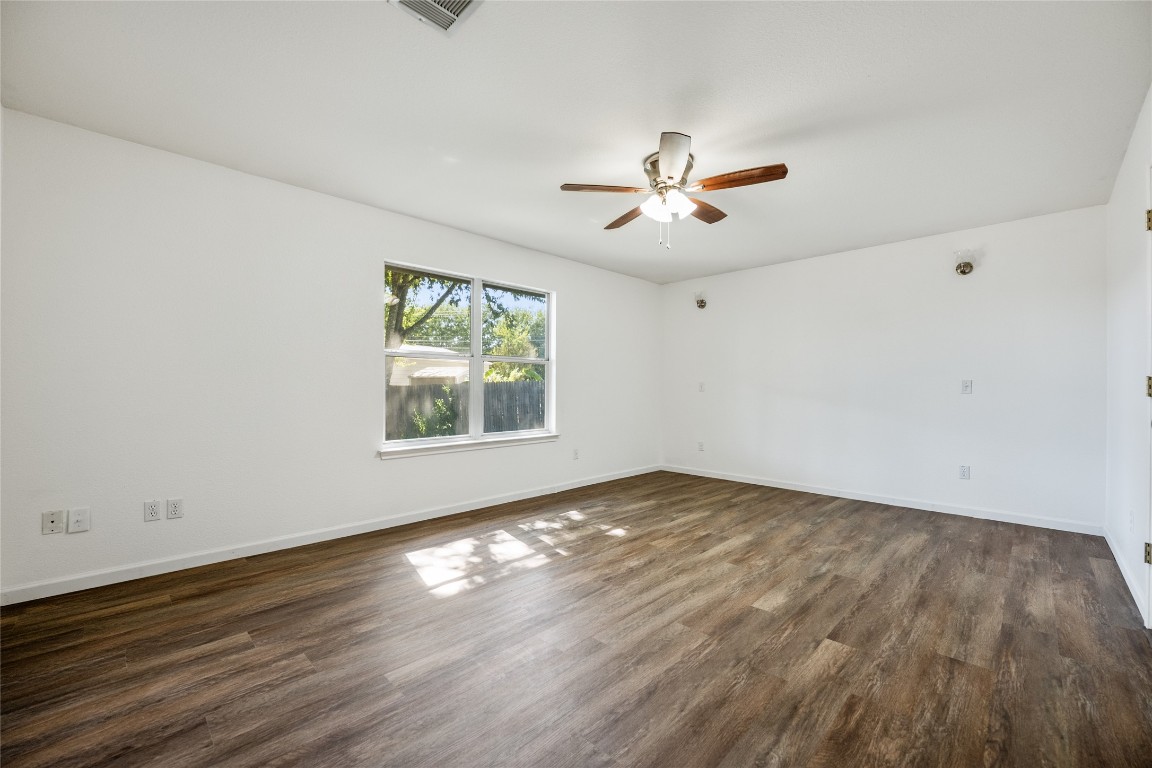 1564 Lorson Loop Round Rock, TX 78665 - Photo 13 of 27 Unfurnished room with dark wood-style floors and a ceiling fan