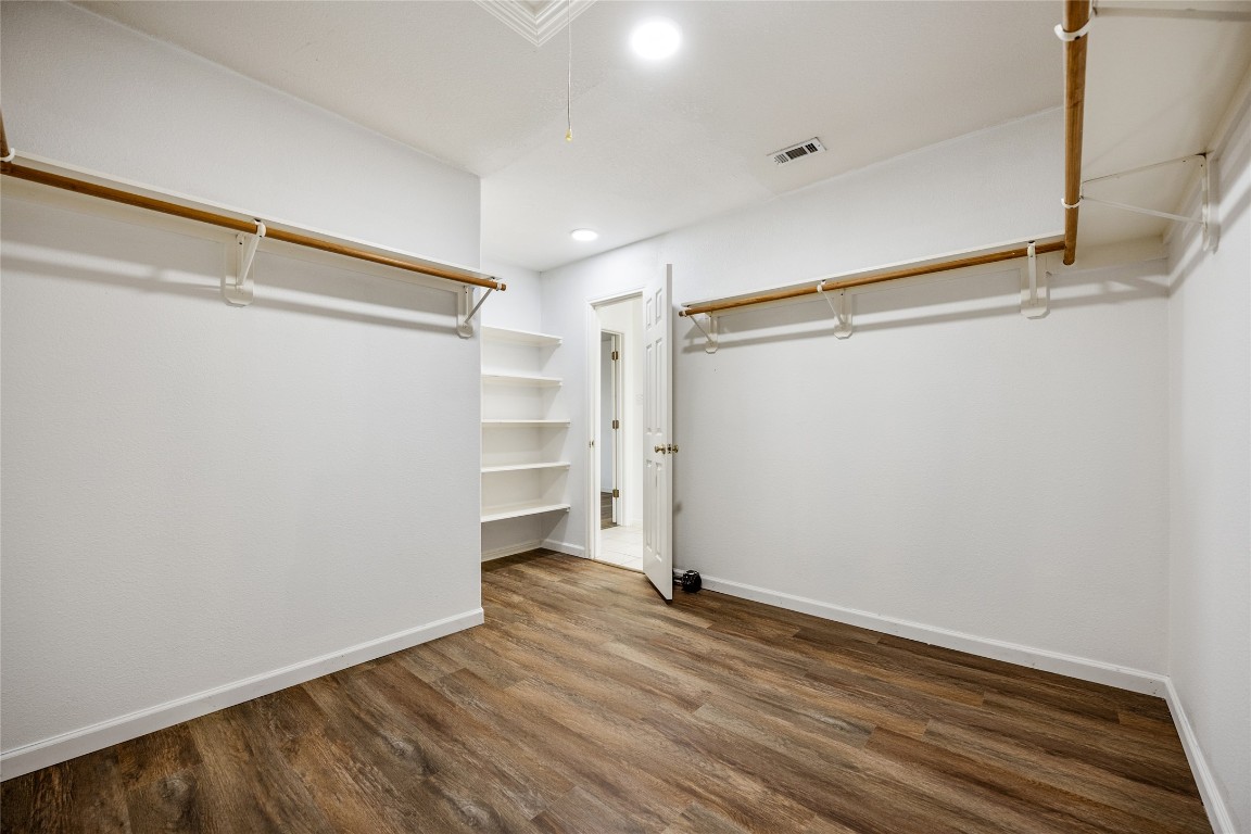 1564 Lorson Loop Round Rock, TX 78665 - Photo 15 of 27 Walk in closet with dark wood-type flooring and attic access