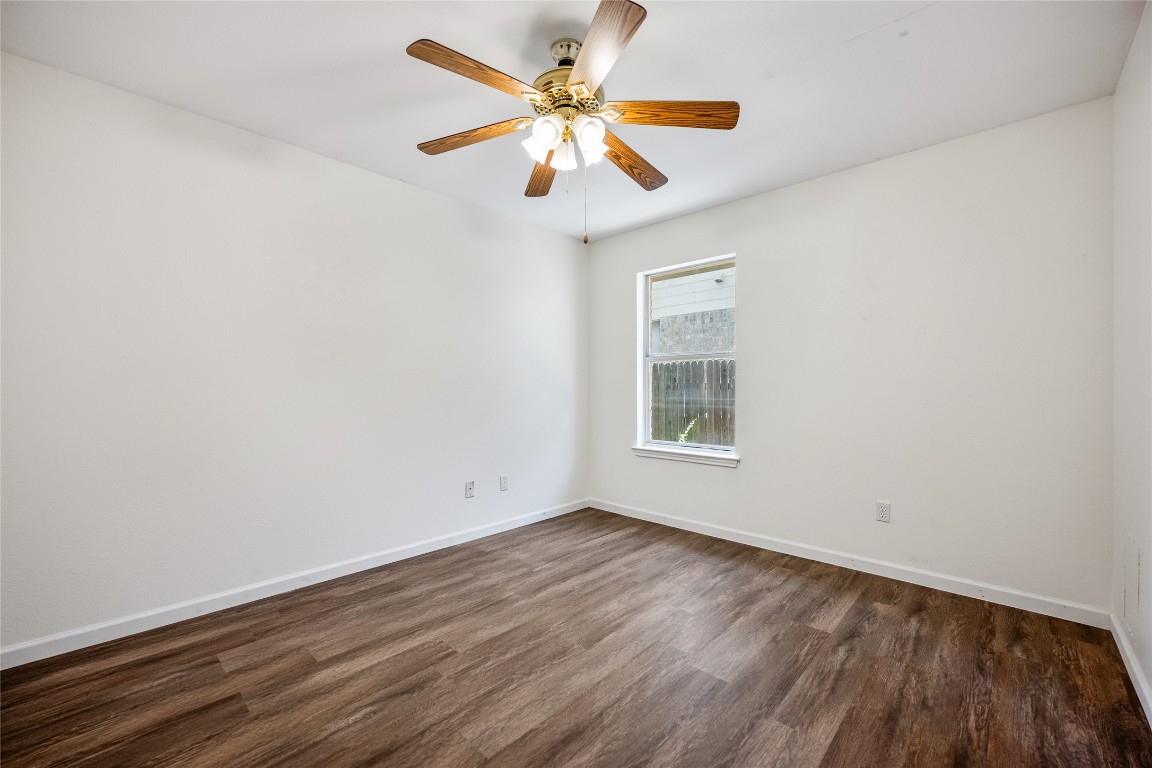 1564 Lorson Loop Round Rock, TX 78665 - Photo 18 of 27 Unfurnished room with dark wood-type flooring and ceiling fan