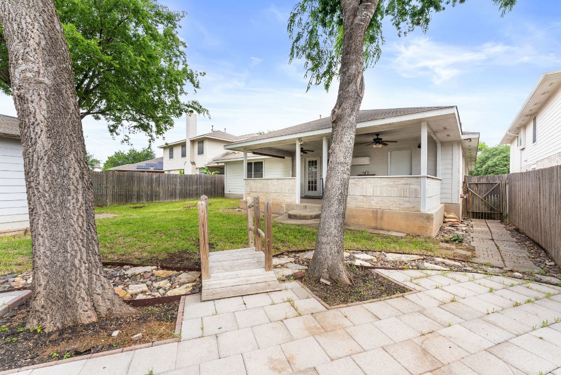 1564 Lorson Loop Round Rock, TX 78665 - Photo 23 of 27 Back of house with a ceiling fan, a fenced backyard, and a gate