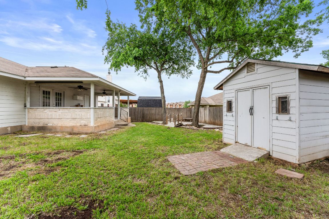 1564 Lorson Loop Round Rock, TX 78665 - Photo 25 of 27 Fenced backyard with a ceiling fan, a storage shed, french doors, and a patio area