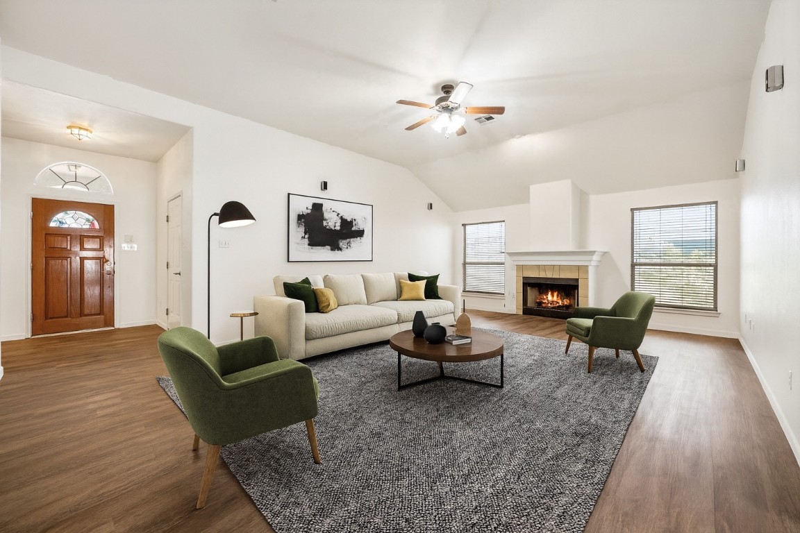 1564 Lorson Loop Round Rock, TX 78665 - Photo 3 of 27 Living room with a tile fireplace, dark wood finished floors, ceiling fan, and lofted ceiling
*Virtually staged*